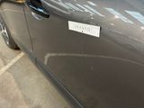 a car with a sticker on the side of it ' s door
