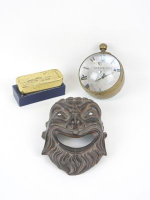 a clock and a bottle opener sitting next to each other