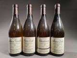 four bottles of wine are lined up on a table