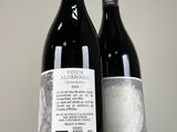 two bottles of wine sitting next to each other on a table