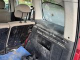 a red van with two seats in the back of it