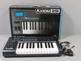 an image of a black and white electronic keyboard with a charger