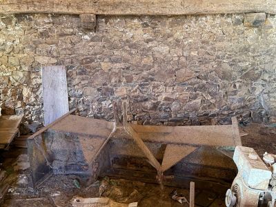 a picture of a room with a stone wall and a wooden bench