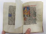 a person holding an open book with a picture on it