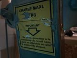 a yellow sign on a blue machine that says charge maxi