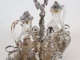 a silver plate with a silver tea set on it