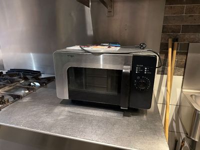 a microwave that is sitting on a counter in a kitchen