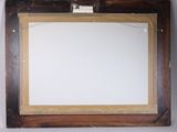 an image of a picture of a mirror hanging on a wall