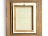 an old picture frame with a white background and a brown wood frame
