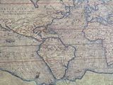 an old map of the world on display in a museum