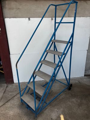 a blue metal stair cart with a blue handrail