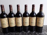six bouteilles de vin sont alignées sur une table