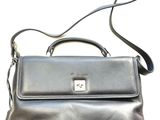 the black purse is sitting on a white surface