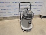 an industrial vacuum cleaner is sitting on the floor in front of a wall