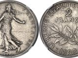 a close up of a coin with a woman on it