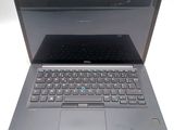 a laptop that is open on a white surface