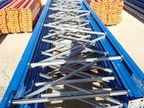 a close up of a long metal structure with a person standing in front of it