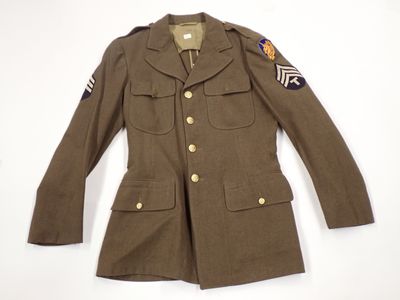 an old military jacket with patches on the sleeves and shoulder