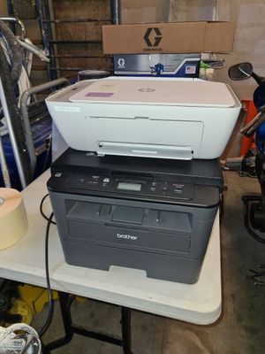 a printer sitting on top of a printer on a table