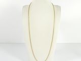 un torse de mannequin blanc orné d'une chaîne en or