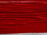a red blanket that is laying on the floor
