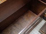 a wooden bench with a drawer underneath it