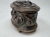 a silver box with a design on it on a table