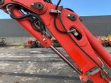 a red excavator that is sitting in a parking lot