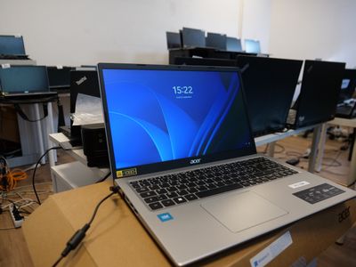 a laptop computer sitting on a desk in a room