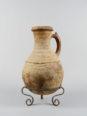 an old vase with a handle on a stand on a white background
