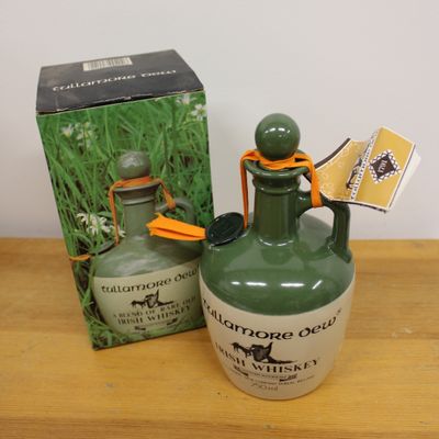 a bottle of liquor sitting on a table next to a box
