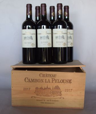 six bottles of red wine in a wooden box on a table