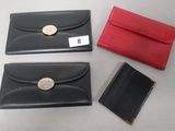 three black and red leather wallets and a red and black card case