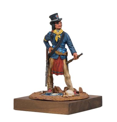 the figurine of a man with a rifle stands on a wooden base