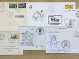many different stamps and envelopes laid out on a table