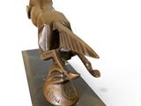 statue of a bird perched on a shoe on a marble base