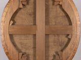 a close up of a wooden sculpture of a cross on a stand