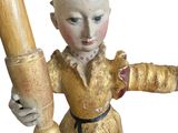 a statue of a woman holding a baseball bat on a white background