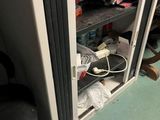 an image of a computer desk with a lot of clutter on it