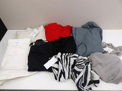 a lot of clothes that are on a white table