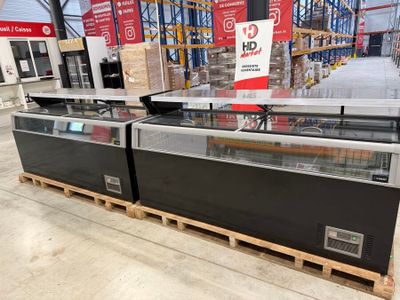 two refrigerated refrigerators in a store on pallets