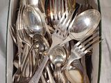 a box full of silver spoons and spoons