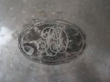 a silver plate with a monogram on it