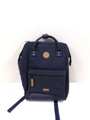 navy blue backpack with leather handles and zippers sitting on a white surface