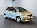 a picture of a silver toyota yaris parked in a showroom