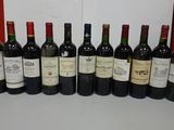 several bottles of wine are lined up in a row on a table