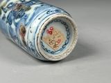 a blue and white vase sitting on a table
