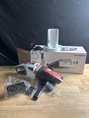 une photo d'une perceuse électrique filaire posée sur une table en bois