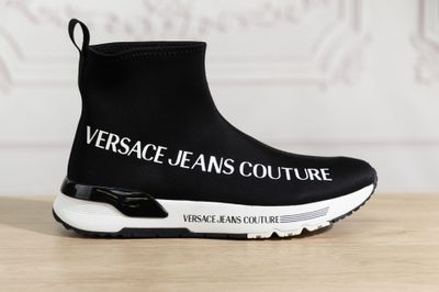 black and white sneakers with the words versa jeans couture written on them