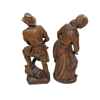 pair of wooden figurines of a man and a woman